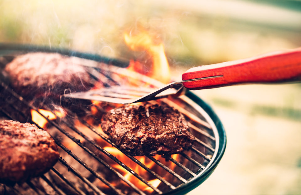 Grilling burgers on a charcoal grill