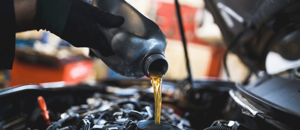 Mechanic performing oil change.