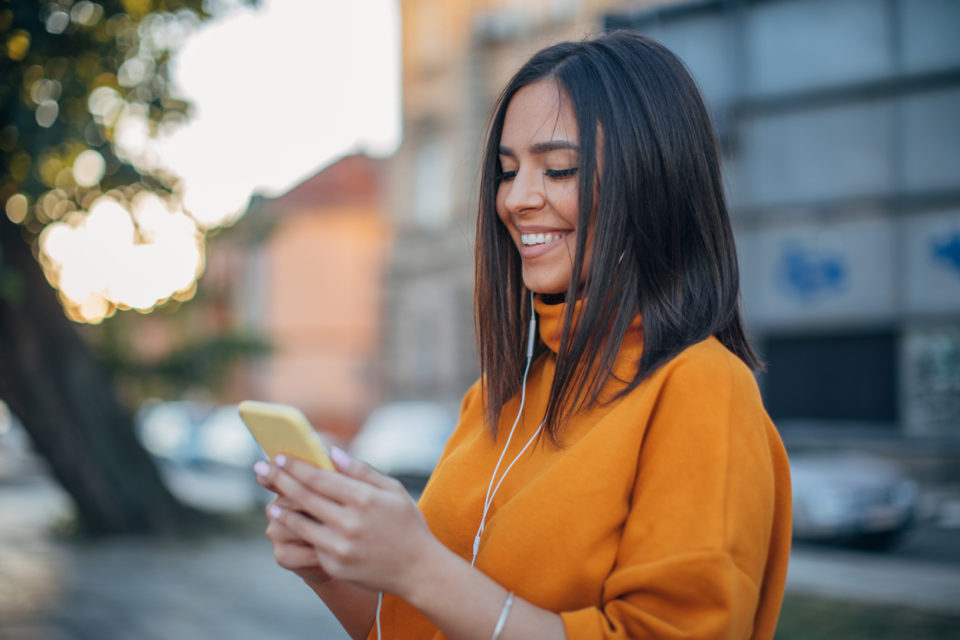 Woman listening to music in a turtleneck sweater