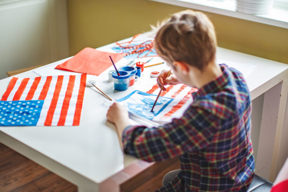 Child draws the American Flag