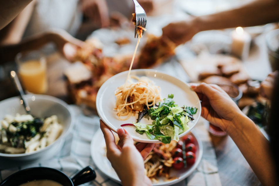 Group of people sharing food at restaurant