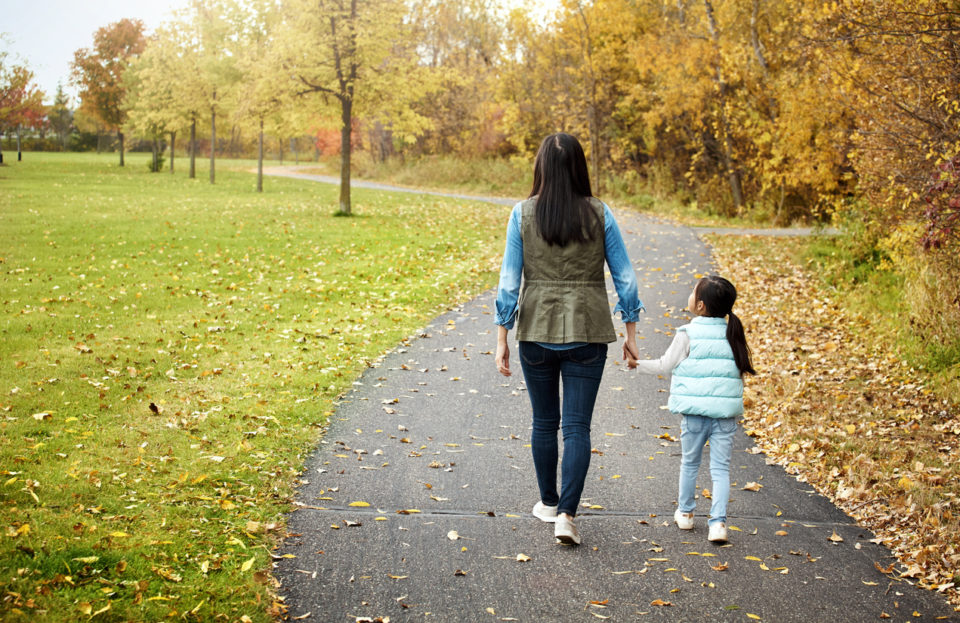 mother and her little daughter enjoying a walk outdoors