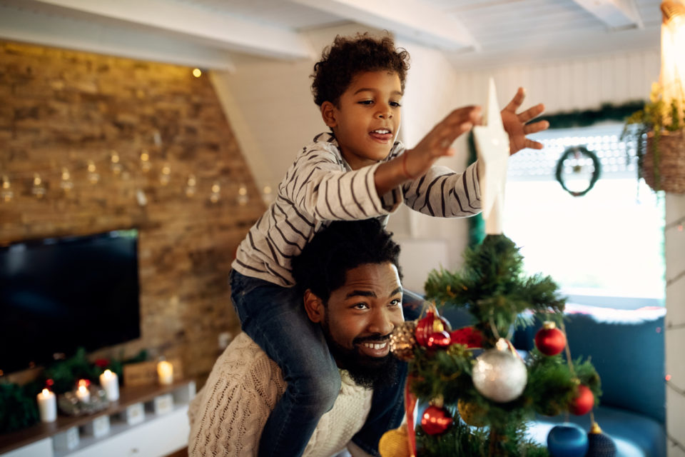 son and father decorating for Christmas