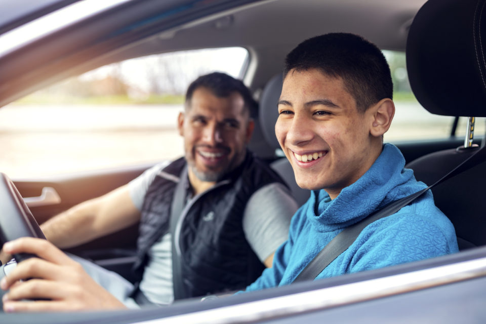 Teenage boy having driving lesson with male instructor