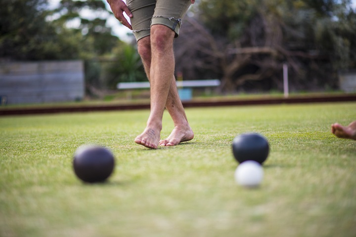 Close up of a man playing game bocce outdoors