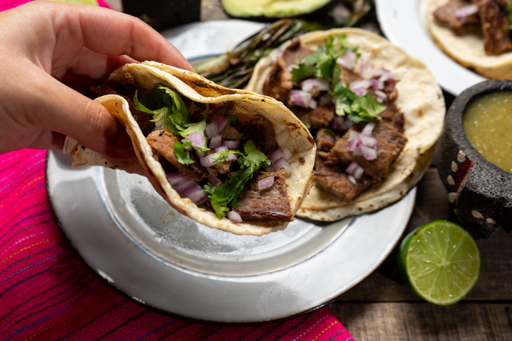 Traditional grilled beef steak tacos on wooden background. Mexican food