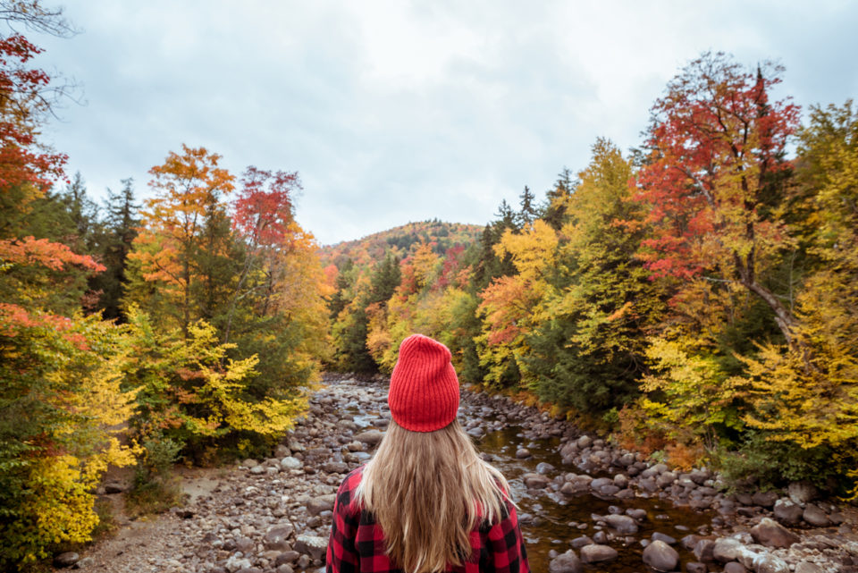 Female hiker surrounded by beautiful fall colors