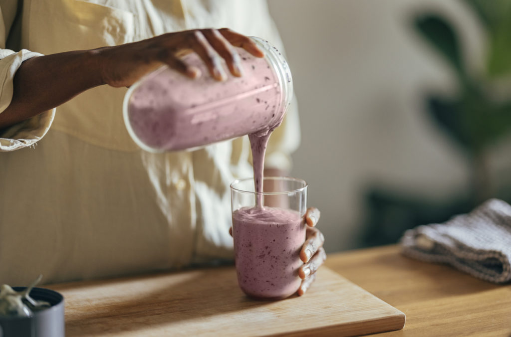 woman pouring smoothie